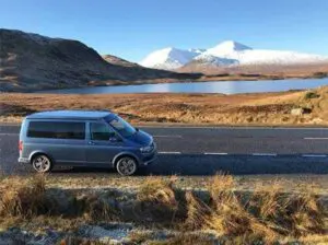 VW camper van with mountains in the background